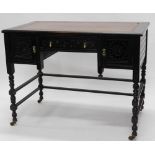 A 19thC ebonised Aesthetic movement writing table, the rectangular top with a brown and gilt tooled