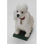 An unusual freestanding figure of a poodle, with Watneys advertising barrel collar, in white and gre