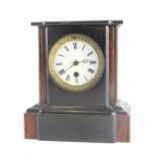 A late 19thC French black slate and red marble mantel timepiece, with white enamel dial, 23cm high.