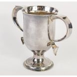 A George III silver two handled loving cup, the bell shaped body flanked by thumb mould handles on a