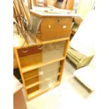 A shoe shine box, newspaper rack, freestanding bookcase with sliding doors.