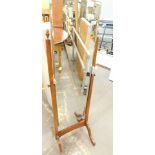 A walnut cheval mirror, with arch plate on splayed legs.