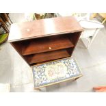 A mahogany open bookcase, and a stool with wool work seat, on square tapering legs.