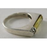 A silver Art Deco style dress ring, set with yellow and small white stones.