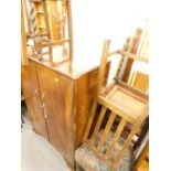 A walnut two door cupboard, a set of three oak dining chairs, and an Edwardian walnut chair.