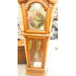 A Tempus Fugit grandfather clock, with two weights and pendulum.