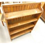 A small oak open bookcase, with shaped end supports, 77cm wide.