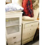 A cream painted pine four drawer chest of drawers, a similar unit with glazed door, and a tub chair.