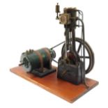 A vertical steam engine, with fly wheel and motor, on a wooden plinth, 60cm wide, 44cm high, 25cm wi