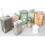 A group of Castrol and other oil cans, green vintage Castrol cans, yellow Gasoline and others.