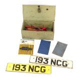 A group of automobilia, comprising a wooden trunk, two vintage number plates for 193 NCG, a foot pum