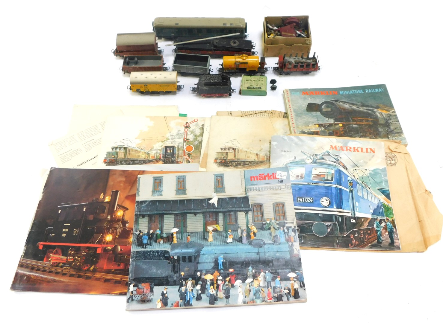 OO gauge railway accessories, comprising a Marklin carriage, Dinky Toys station staff, part wagons,