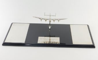 An Elizabeth II silver Bomber Command memorial plaque, formed as a Lancaster Bomber, on a plinth bas