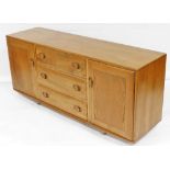 An Ercol light elm sideboard, the three central drawers flanked by two cupboards, 68cm high, 153cm w