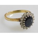 An 18ct gold and sapphire ring, basket set in a surround of diamonds, size P/Q, 4.7g.