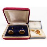 A pair of tiger's eye cuff links, set in rose coloured metal, stamped 9K, cased, together with 10ct
