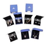 Swarovski Crystal jewellery, including pendant necklaces, pairs of earrings and a scroll brooch, all