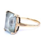 An aquamarine dress ring, the emerald cut stone high claw set in yellow metal, approx 5ct, size Q/R,