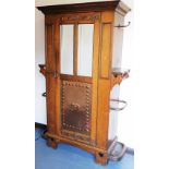 A late 19th/early 20thC Arts and Crafts hall cupboard by Thomas Edwards, Newcastle, the top with a