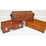 An early 20thC brown leather case, with brass catches and stud work, initialled CMF, 76cm wide, and