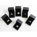 Six silver and paste set dress rings, all boxed.