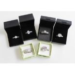 Six silver and paste set dress rings, all boxed.
