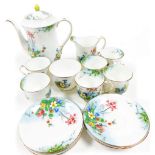An Aynsley six piece porcelain coffee service, hand painted with flowers against a white ground with