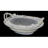 A Belleek porcelain basket, of oval form, with a three strand lattice work base, applied flowers to