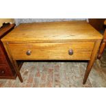 An oak side table, the rectangular top with rounded corners, above a deep frieze fall, raised on squ