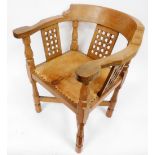 A Robert Thompson Mouseman oak monk's chair, with a curved back and shaped arms, over three lattice
