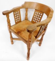 A Robert Thompson Mouseman oak monk's chair, with a curved back and shaped arms, over three lattice