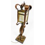An early 20thC copper and brass Art Nouveau electric table lamp, the lantern shaped shade with opaqu
