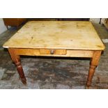 A Victorian pine kitchen table, the rectangular top with rounded corners, above a small frieze drawe