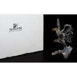 A Swarovski crystal figure of an eagle on a tree branch, A7670, 13cm high, in fitted box with outer