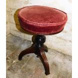 A Victorian mahogany adjustable piano stool, with a padded seat, above a turned column and reeded sp