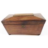 A Regency mahogany sarcophagus shaped tea caddy, the hinged lid enclosing two separate lidded divisi