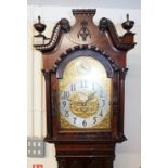 A Victorian mahogany longcase clock, the arched dial with applied elaborate floral and pierced decor