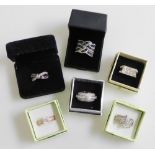 Six silver and paste set dress rings, all boxed.