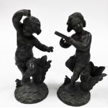 A pair of 19thC spelter figures of putti, one playing a tambourine and the other dancing, unmarked,