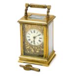 A late 19thC brass cased carriage clock, the circular enamel dial bearing Roman numerals, against a