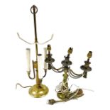 Three table lamps, comprising a brass figure of a putto holding a lamp, on a marble base, 33cm high,