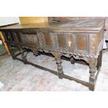 A 17thC style oak dresser, the top with a moulded edge above panelled drawers and carved panelled do