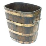A coopered twin handled oak bucket or planter, of tapering form, with copper banding, 43cm high, 47c