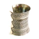 A Middle Eastern silver cuff, of wide form, with variously banded decoration, 135g.