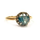 A diamond and gem set dress ring, set with a central blue tourmaline stone, 1.5ct, surrounded by twe