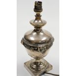 An early 20thC silver plated table lamp, of baluster form, with relief moulded lion mask decoration,