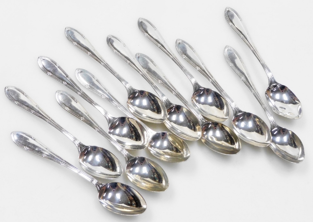 A set of twelve silver coffee spoons, with line and raised clover decoration to each handle, Sheffie