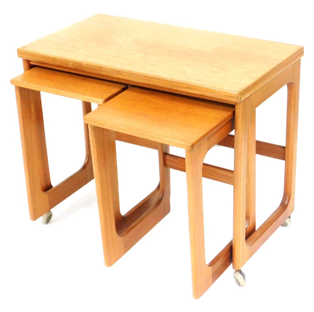 A McIntosh of Kirkcaldy teak nest of three tables, the larger tea table with a rectangular hinged fo