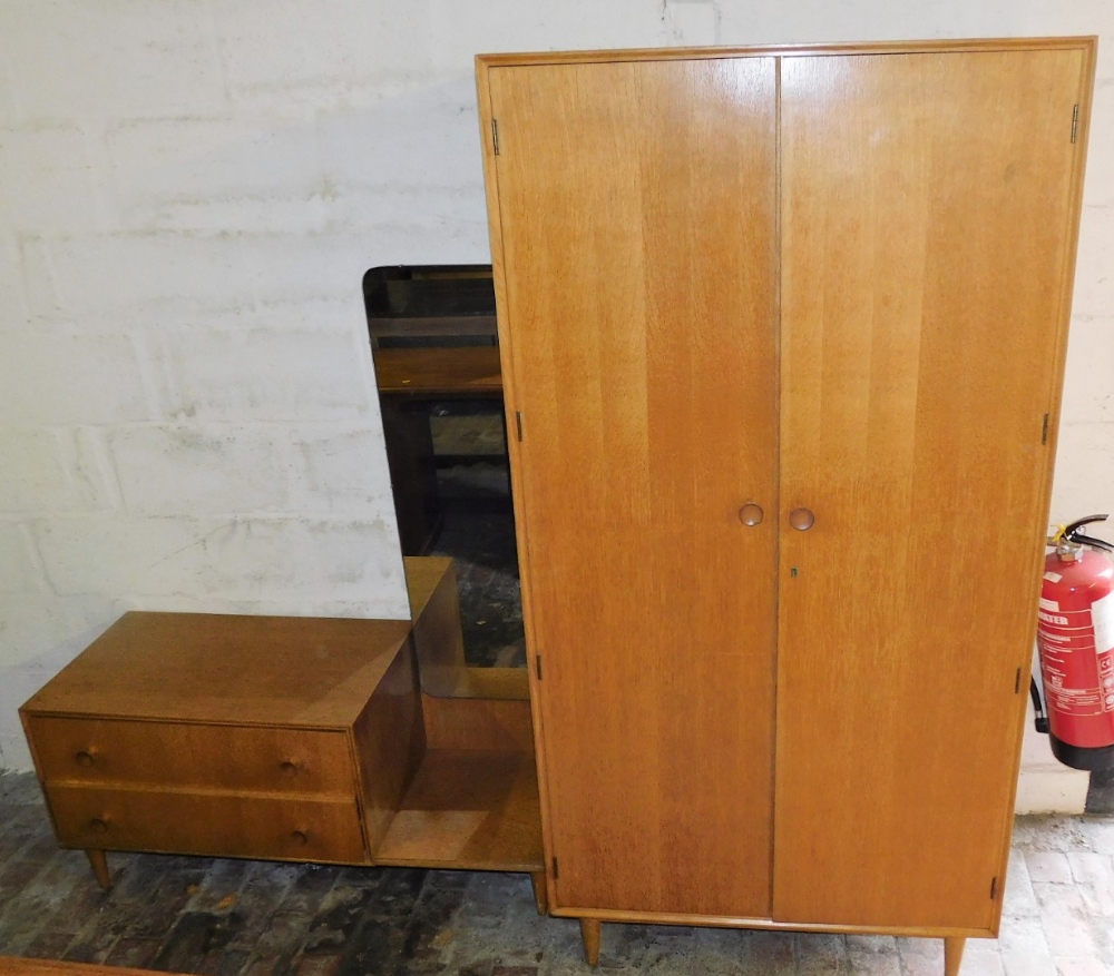 A 1950's Meredew oak wardrobe, of plain form, with turned wooden handles, on square tapering legs, 1