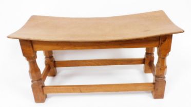 A Robert Thompson Mouseman oak double dish topped stool, on octagonal supports with carved mouse to
